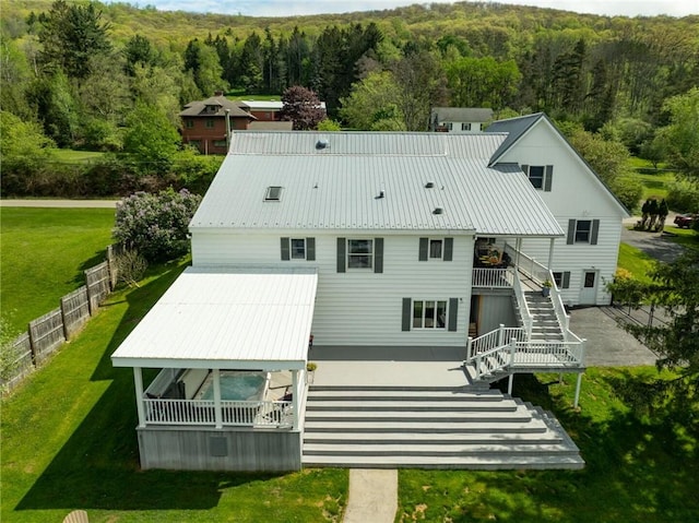 557 Interstate Pkwy, Foster-Town, PA 16701 - rear view of house with stairs, a forest view, and metal roof