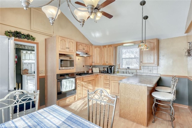 4231 Cauwels Rd, Arcadia, NY 14505 - kitchen with oven, light brown cabinets, stainless steel microwave, lofted ceiling, and a sink