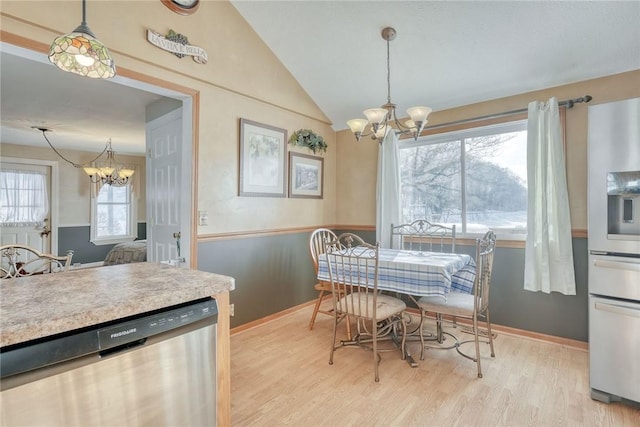 4231 Cauwels Rd, Arcadia, NY 14505 - dining area with a chandelier, lofted ceiling, light wood-type flooring, and baseboards