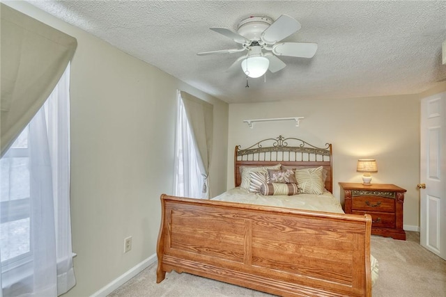 4231 Cauwels Rd, Arcadia, NY 14505 - bedroom with light colored carpet, multiple windows, a textured ceiling, baseboards, and a ceiling fan