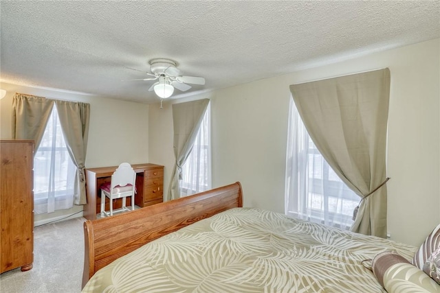 4231 Cauwels Rd, Arcadia, NY 14505 - carpeted bedroom with multiple windows, a textured ceiling, and ceiling fan