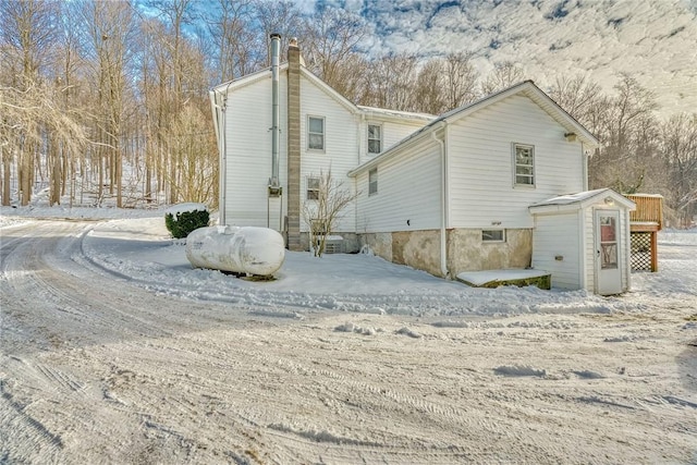 4231 Cauwels Rd, Arcadia, NY 14505 - snow covered property featuring a chimney and a shed