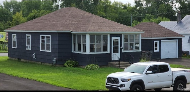 925 Calvert St, Rome-Inside, NY 13440 - view of front of property featuring a shingled roof, a garage, a front lawn, and driveway