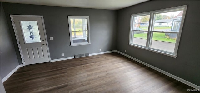 925 Calvert St, Rome-Inside, NY 13440 - foyer entrance featuring healthy amount of natural light and dark wood-type flooring