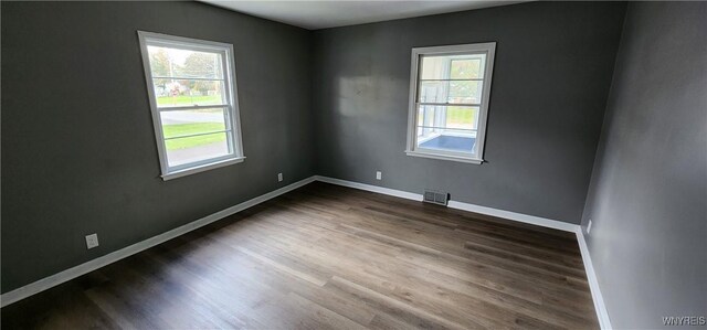 925 Calvert St, Rome-Inside, NY 13440 - spare room with healthy amount of natural light, dark wood-style flooring, and baseboards