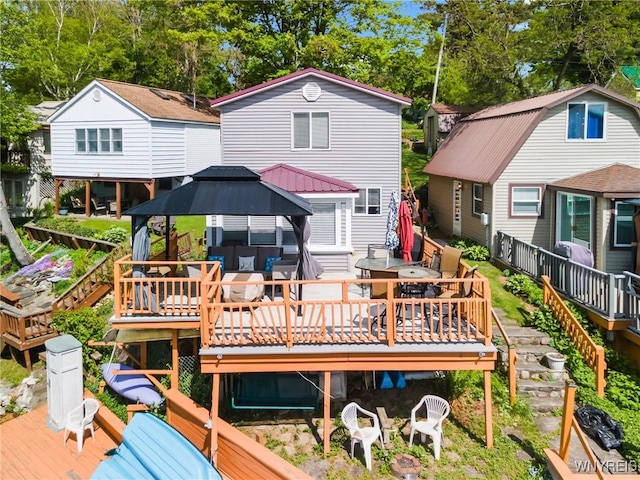 328 Lakeview Blvd, Machias, NY 14042 - rear view of house featuring a gazebo, outdoor dining area, a wooden deck, and view of wooded area