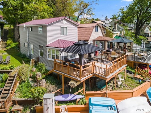 328 Lakeview Blvd, Machias, NY 14042 - rear view of property with a deck, metal roof, outdoor dining space, and stairway