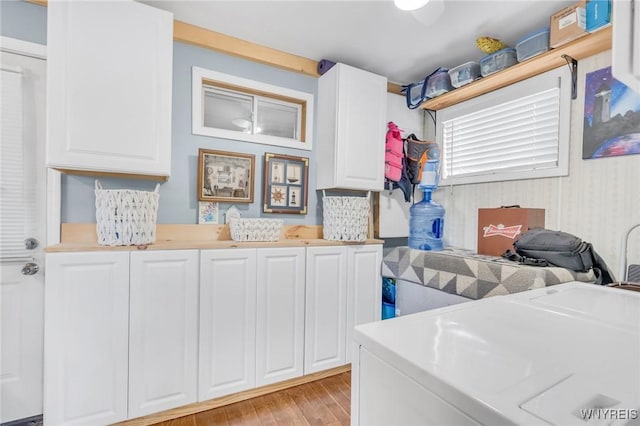 328 Lakeview Blvd, Machias, NY 14042 - laundry area with washing machine and clothes dryer, light wood-type flooring, and cabinet space