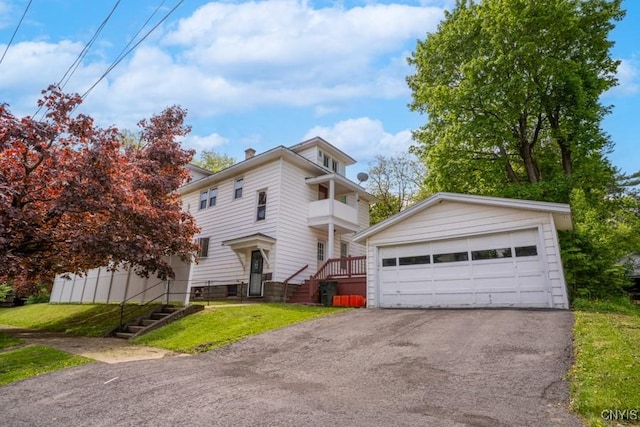 1628 Mohawk St, Utica, NY 13501 - view of front of home featuring a garage, a front yard, a balcony, and stairway