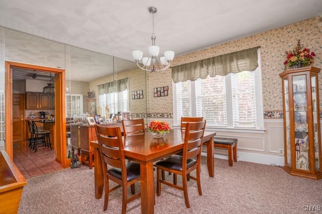 1628 Mohawk St, Utica, NY 13501 - dining area featuring wallpapered walls, a chandelier, a wainscoted wall, healthy amount of natural light, and carpet