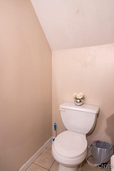 1628 Mohawk St, Utica, NY 13501 - bathroom featuring lofted ceiling, toilet, tile patterned floors, and baseboards