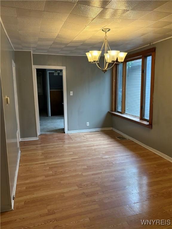 68 Decker St, Buffalo, NY 14215 - unfurnished room with a chandelier and wood finished floors