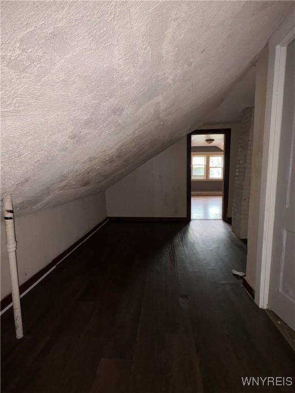 68 Decker St, Buffalo, NY 14215 - bonus room featuring a textured ceiling, lofted ceiling, and wood finished floors