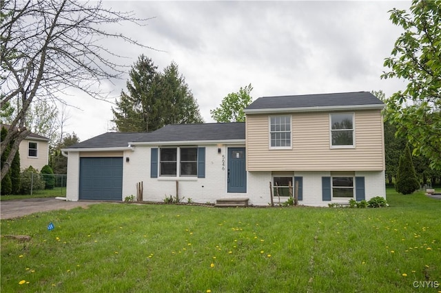 5646 Vistula, Cicero, NY 13029 - split level home featuring an attached garage, brick siding, asphalt driveway, and a front yard