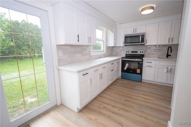 5646 Vistula, Cicero, NY 13029 - kitchen with stainless steel microwave, range with electric cooktop, a sink, tasteful backsplash, and light countertops