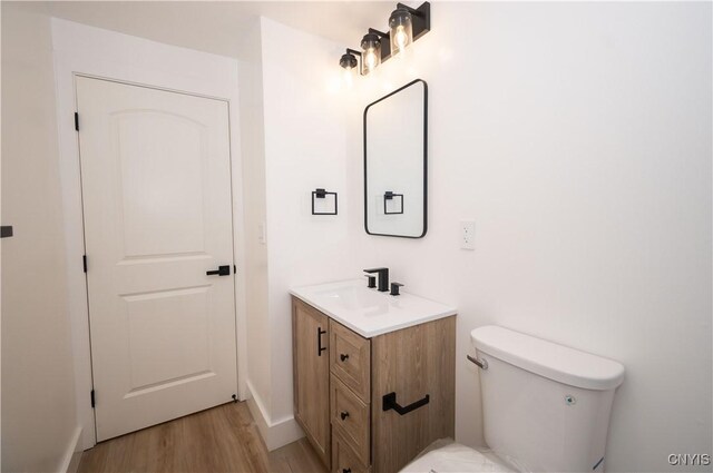 5646 Vistula, Cicero, NY 13029 - bathroom featuring wood finished floors, vanity, and toilet