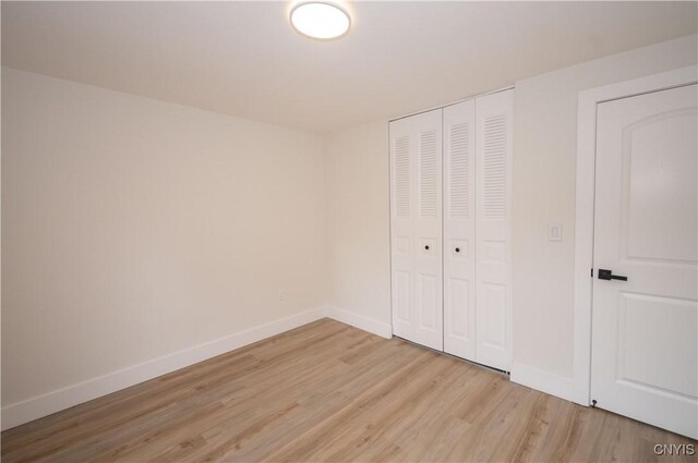 5646 Vistula, Cicero, NY 13029 - unfurnished bedroom with light wood-style floors, baseboards, and a closet