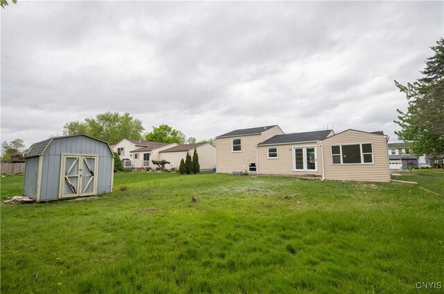 5646 Vistula, Cicero, NY 13029 - back of house featuring a storage unit, an outdoor structure, and a lawn