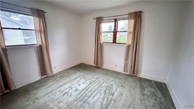 spare room with carpet flooring and baseboards