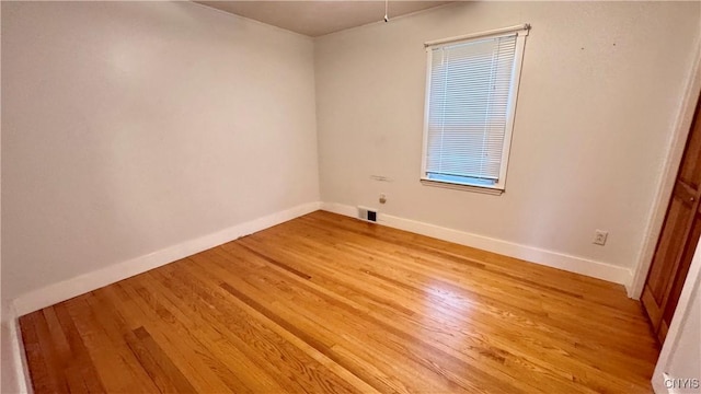 unfurnished room featuring light wood-type flooring and baseboards