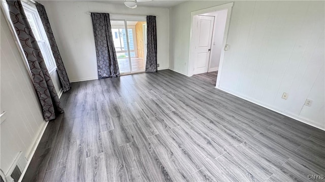 empty room with wood finished floors and baseboards