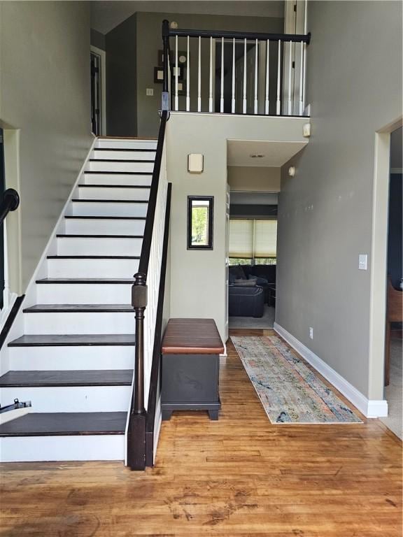 1 Woodsview Dr, Big Flats, NY 14903 - stairs featuring wood finished floors, baseboards, and a high ceiling