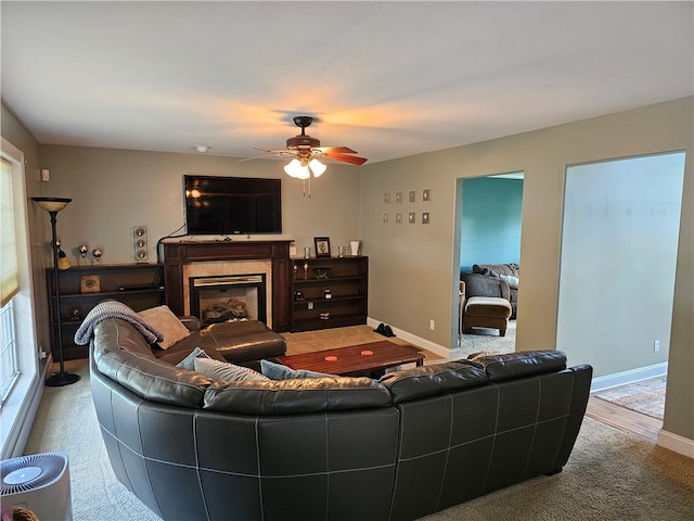 1 Woodsview Dr, Big Flats, NY 14903 - carpeted living room featuring a glass covered fireplace, a ceiling fan, and baseboards