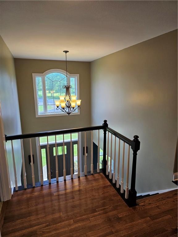 1 Woodsview Dr, Big Flats, NY 14903 - staircase with a chandelier, wood finished floors, and baseboards