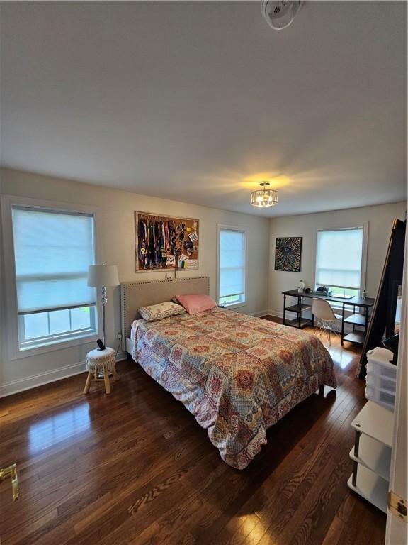 1 Woodsview Dr, Big Flats, NY 14903 - bedroom with wood finished floors, baseboards, and a chandelier