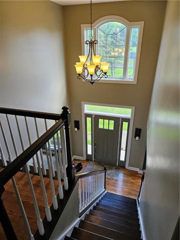 1 Woodsview Dr, Big Flats, NY 14903 - foyer with baseboards, a chandelier, a high ceiling, wood finished floors, and stairs