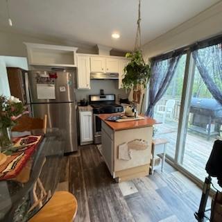 3384 Huggins Rd, Tyrone, NY 14815 - kitchen featuring appliances with stainless steel finishes, under cabinet range hood, plenty of natural light, white cabinetry, and crown molding