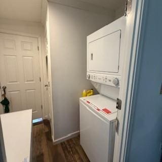 3384 Huggins Rd, Tyrone, NY 14815 - laundry room featuring estacked washer and dryer, dark wood-style floors, and baseboards