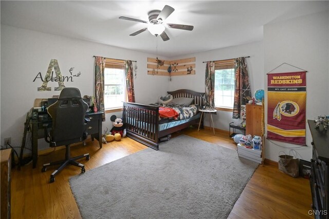 161 Mcclure Rd, Salisbury, NY 13470 - bedroom with multiple windows, ceiling fan, and wood finished floors