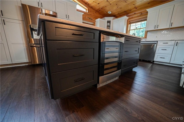 161 Mcclure Rd, Salisbury, NY 13470 - kitchen with beverage cooler, lofted ceiling, appliances with stainless steel finishes, dark wood-style floors, and white cabinets