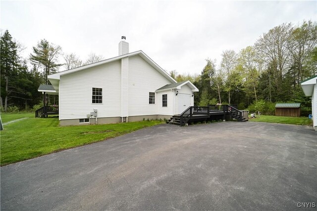 161 Mcclure Rd, Salisbury, NY 13470 - view of property exterior featuring a wooden deck, a chimney, and a yard