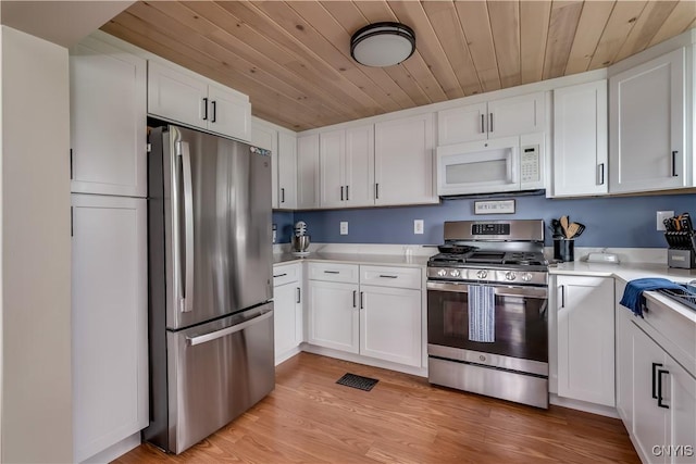 17695 County Route 59, Brownville, NY 13634 - kitchen featuring appliances with stainless steel finishes, wood ceiling, light countertops, and white cabinetry