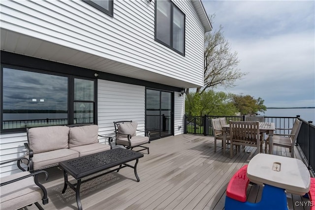 17695 County Route 59, Brownville, NY 13634 - wooden terrace with outdoor dining space, an outdoor hangout area, and a water view