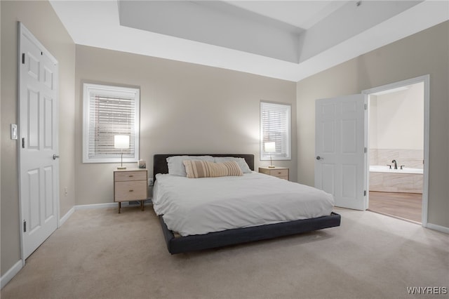 185 York St Unit 1, Buffalo, NY 14213 - bedroom with light colored carpet, baseboards, and ensuite bathroom