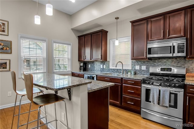 185 York St Unit 1, Buffalo, NY 14213 - kitchen with appliances with stainless steel finishes, a sink, tasteful backsplash, and light stone countertops