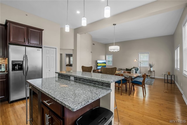 185 York St Unit 1, Buffalo, NY 14213 - kitchen with stainless steel fridge, a kitchen breakfast bar, light wood-style flooring, a kitchen island, and open floor plan