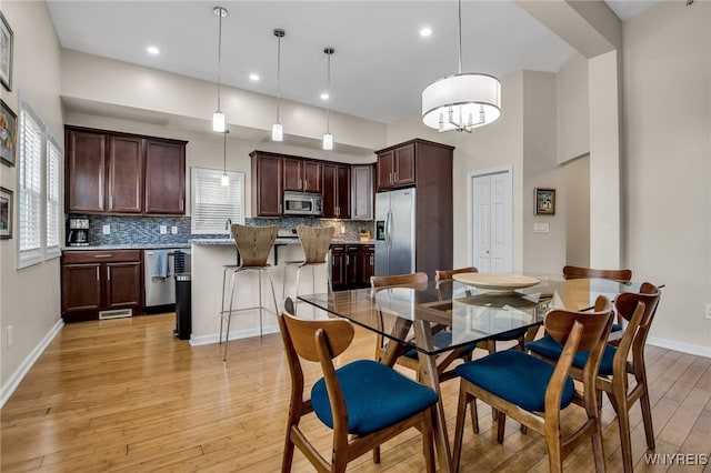 185 York St Unit 1, Buffalo, NY 14213 - dining space featuring light wood-type flooring, baseboards, a chandelier, and recessed lighting