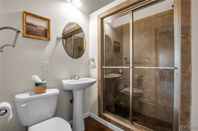185 York St Unit 1, Buffalo, NY 14213 - bathroom featuring toilet, a shower stall, a sink, and baseboards