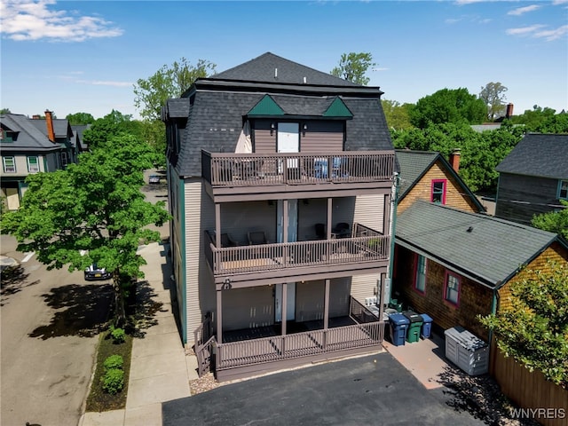 185 York St Unit 1, Buffalo, NY 14213 - rear view of property with a balcony, driveway, and a shingled roof
