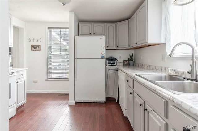 71 Champion St, Champion, NY 13619 - kitchen with white appliances, a sink, light countertops, dark wood-style floors, and baseboards