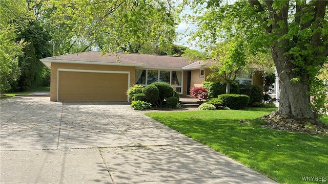 view of front facade with concrete driveway, a garage, and a front lawn