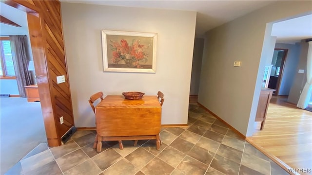dining area featuring baseboards and tile patterned flooring