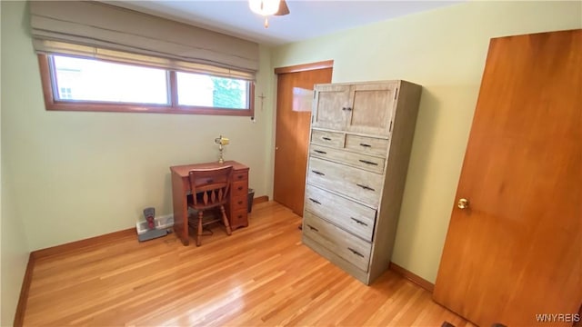 bedroom featuring light wood finished floors, baseboards, and ceiling fan