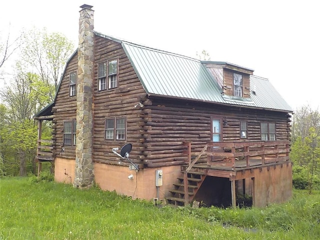 6900 White Rd, Conesus, NY 14435 - back of property featuring log exterior, metal roof, a deck, and a chimney