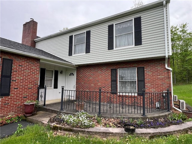 8584 Vieley Rd, Campbell, NY 14821 - view of front of property with brick siding, a patio, and a chimney