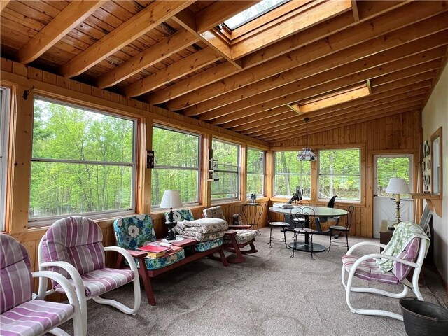 8584 Vieley Rd, Campbell, NY 14821 - sunroom with vaulted ceiling, carpet flooring, a skylight, and wood walls
